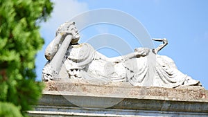 Statue in a cemetery with clouds