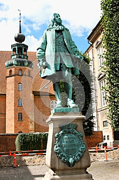 The statue of Chancellor Peder Griffenfeld and a tower in Copenhagen, Denmark photo