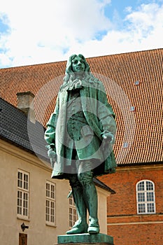 The statue of Chancellor Peder Griffenfeld and a tower in Copenhagen, Denmark photo