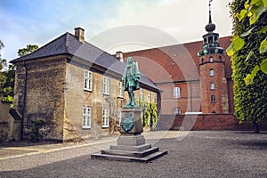 The statue of Chancellor Peder Griffenfeld and a tower in Copenhagen photo
