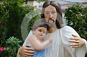 Statue of Christ and Child In Hug. photo