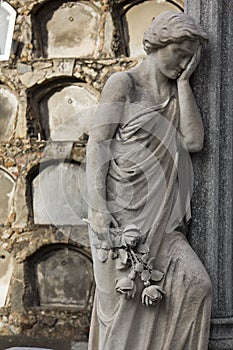 Statue of a classical woman regretting the loss of a beloved one