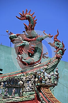 A statue of a dragon decorates the ridgepole of a Buddhist temple in SaÃÂ¯gon, Vietnam photo