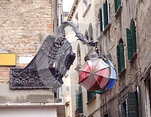 Statue of a dragon holding umbrellas in Venice, Italy