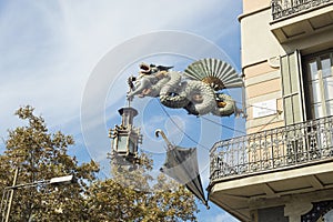 Statue of dragon at `House of Umbrellas` House Bruno Cuadros located in Las Ramblas in Barcelona, Catalonia, Spain photo