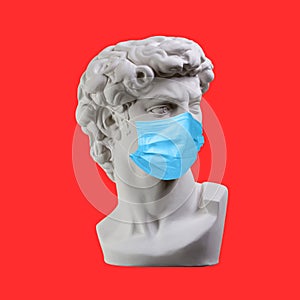 Statue. Earphone. Isolated. Gypsum statue of David`s head. Man. Creative. Plaster statue of David`s head in medical mask. Minima