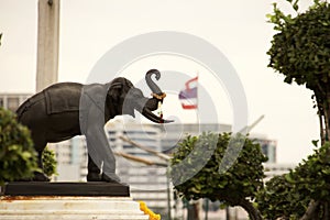 Statue of an elephant and a Thai flag at the palace in Thailand