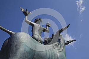 The statue of Europe is sitting on a bull. Sculpture of Europe, mother of King Minos, riding a bull in Agios Nikolaos, Crete,