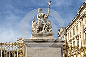 Statue in exterior fence of facade of Versailles Palace