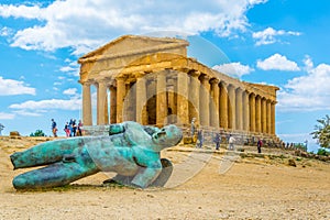 Statue of fallen Icaro in front of the Concordia temple in the Valley of temples near Agrigento in Sicily, Italy