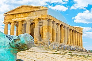 Statue of fallen Icaro in front of the Concordia temple in the Valley of temples near Agrigento in Sicily, Italy photo