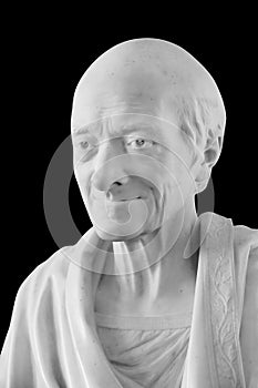 Statue of the famous French philosopher Voltaire isolated on black with clipping path