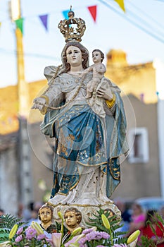 statue of the figure of the saint of our lady of the good trip parading on top of a litter in Malpica do Tejo