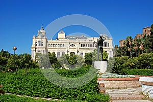 Statue of the flower seller Biznaguero in the Pedro Luis Alonso gardens with the city hall to the rear, Malaga, Spain. photo