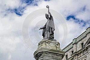 Statue of Francois Xavier de Montmorency Laval with beautiful blue cloudy sky in background photo