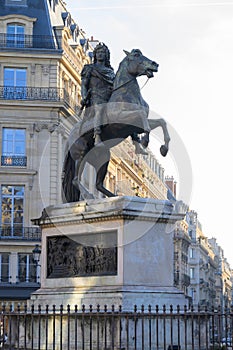 Statue of the French King Louis XIV (14th) in the center of Victories Place in Paris under a pure cold blue sky