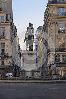 Statue of the French King Louis XIV (14th) in the center of Victories Place in Paris under a pure cold blue sky