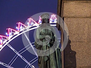 Statue in front of a ferris wheel, Schlossplatz, Stuttgart, Germany