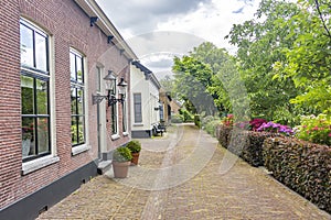A statue in front of the old cottages in the picturesque village of Drimmelen, Netherlands
