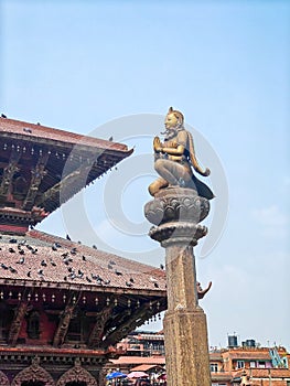 Statue of Garuda god of birds on a stone pillar Patan temple, a historical site in Lalitpur district photo