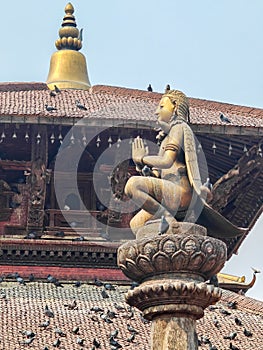 Statue of Garuda god of birds on a stone pillar Patan temple, a historical site in Lalitpur district photo