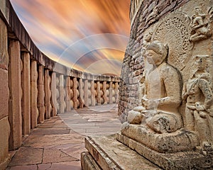 A statue of Gautam Buddha placed beside one of the stupas at Sanchi