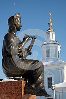 Statue of girl playing flute with church in background, Vologda, Russia