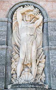 Statue of the god Neptune on the facade a hydroelectric plant. photo