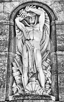 Statue of the god Neptune on the facade a hydroelectric plant. photo