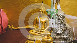 A statue of a golden buddha close-up. Bodhi condition of holy god