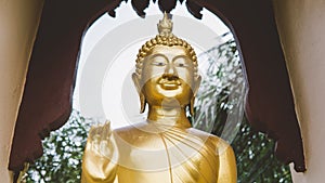A statue of a golden buddha close-up. Bodhi condition of holy god