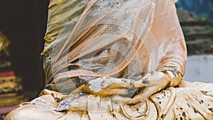 A statue of a golden buddha close-up. Bodhi condition of holy god