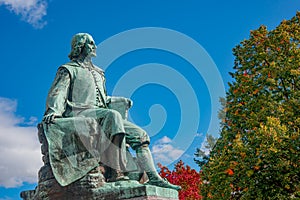 Statue of great scientist Otto von Guericke in red and golden Autumn colors in historical downtown of Magdeburg Germany, at sunny