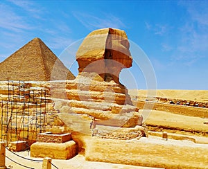 Statue of the Great Sphinx in Giza, Egypt, next to the pyramids of Giza, a human head on the body of a lion