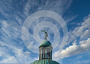 Statue on Green Cupola Against Sky