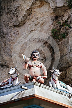 Statue Hindu deities on the roof of temple within Batu Caves. Batu Caves - a complex of limestone caves in Kuala Lumpur, Malesia