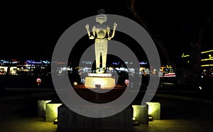 The statue of a Hindu deity with four hands and several faces, night lighting, Asian culture