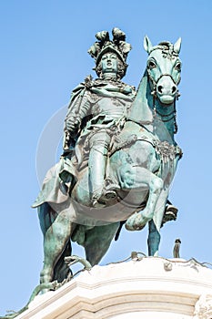 a statue of a horse rider riding on top of a building