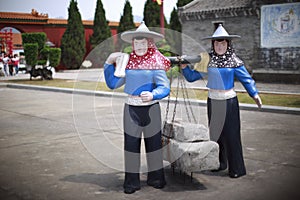 Statue of huian women carry stones