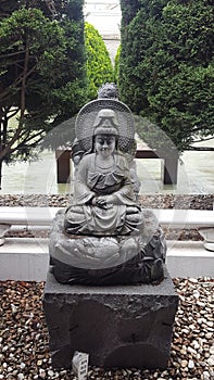 Statue - interesting stone statue in the grounds of Nan Tien Buddhist Temple at Unanderra close to Wollongong, NSW, Australia
