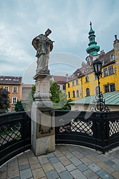 Statue of Jan Nepomucky in the centre of Bratislava, Slovakia, just next to the Sant Michael church on a gray day