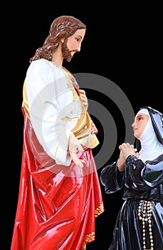 Statue of Jesus Christ and mary. Sacred Heart. Christianity symbol isolated on black background