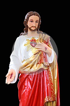 Statue of Jesus Christ. Sacred Heart. Christianity symbol isolated on black background