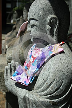 Statue of Jizo with scarf, Japan
