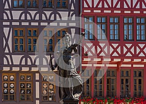 Statue of the judge in front of the half-timbered houses on the Roemerberg in Frankfurt, Germany photo