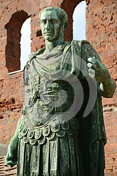 The statue of Julius Caesar in front of the Porta Palatina