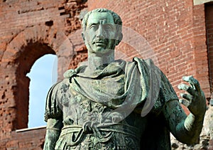 The statue of Julius Caesar in front of the Porta Palatina