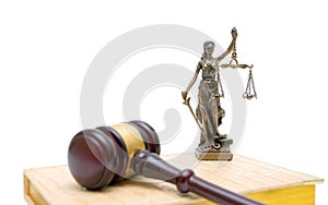 Statue of justice, gavel and book on white background