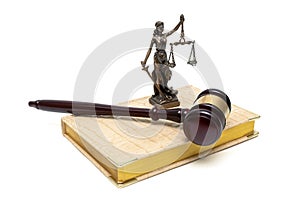 Statue of justice, gavel and book on a white background