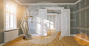 The Statue of Justice - Lady Justice or Iustitia / Justitia the Roman Goddess of Justice in a large empty room as sign for tenancy